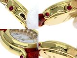 three different views of a gold watch with red stones on it