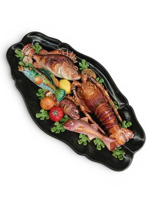 a platter of food with fish and vegetables on it