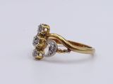 an image of a gold and diamond ring on a white surface
