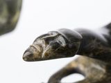 a statue of a lizard that is sitting on top of a table