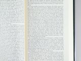 an open book on a table with a pencil in it