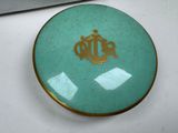 a small plate with a crown on it on a table