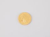 a close up of a gold coin on a white surface