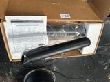 a box with a black object in it on a table