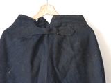 denim skirt with a belt and pockets on a hanger