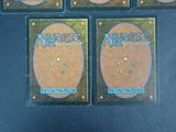 four decks of magic the gathering cards are shown in a display case