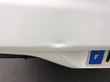 a close up of a white car with a blue sticker on it