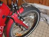 a red bike with a coke can on the back