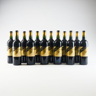 six bottles of wine lined up in a row on a white surface