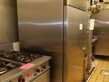 stainless steel appliances in a commercial kitchen with tiled flooring
