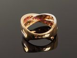 a close up of a gold ring on a black surface