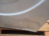 a close up of a washing machine on a wooden pallet