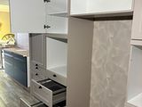 a white cupboard with drawers in the middle of the room