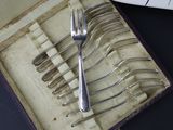 a box with a set of forks and spoons in it