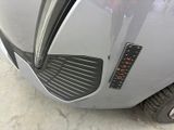 a close up of a car ' s front bumper with a sticker on it