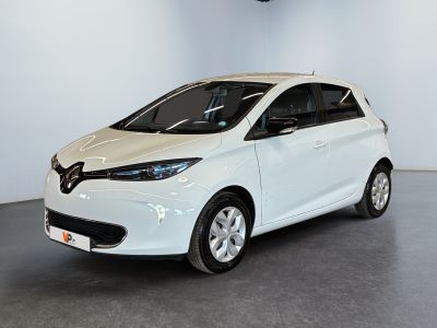 a white car is parked in a large room