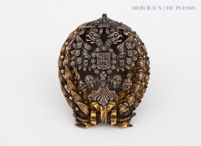 une bague en or ornée d'un aigle sur un fond blanc