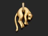 un pendentif en forme de chat en or, serti de diamants, sur fond noir
