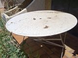 a table that is sitting on the ground in front of a building