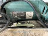 an image of a green electric driller with a cord