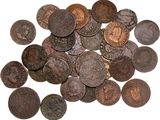a close up of a pile of old coins on a white surface