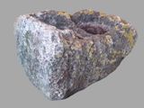 a rock with moss growing out of it on a gray surface