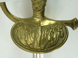 a gold sword with a gold handle on a white background