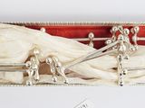 a box with silverware in it on a white surface