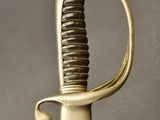 a close up of a sword with a gold handle