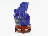a blue vase with a dragon on it sitting on a stand