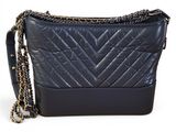 a black purse with a chain strap and a chain strap