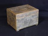 a small wooden box with a design on it