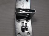 a close up of a metal latch on a wooden surface