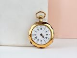 gold plated pocket watch with roman numerals on the face