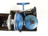 a blue and silver fishing reel in a green box