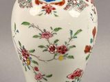 a vase with a lid that has flowers and birds on it