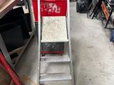 a ladder that is sitting in a room with many other items
