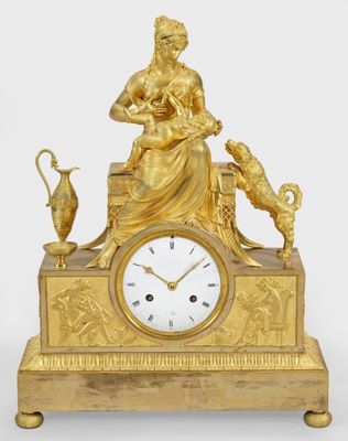 a gold clock with a statue of a woman and a cat