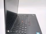 the back of a laptop computer sitting on top of a white table