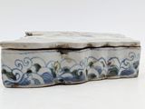 a blue and white box sitting on a white surface
