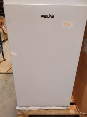 a white refrigerator sitting on a pallet in a warehouse
