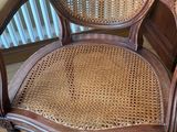 an old chair with a cane back and a cane seat