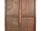 an old wooden armoire with two doors and a drawer