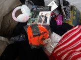 a pile of clothing and other items on a bed