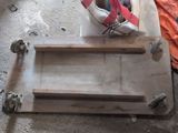someone is working on a piece of wood that is sitting on the floor