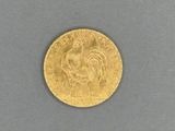 a close up of a gold coin with a rooster on it