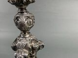 a silver candle that is sitting on top of a table