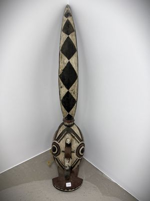 a large wooden sculpture with a black and white design on it
