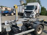 a truck that is parked in a lot with other trucks in the background