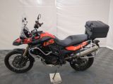 a motorcycle that is sitting on a stand on a checkered floor